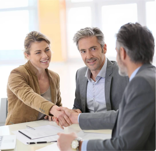 Clients shaking hands with a mortgage broker after securing a home loan through MambaCap Financial mortgage broker services.