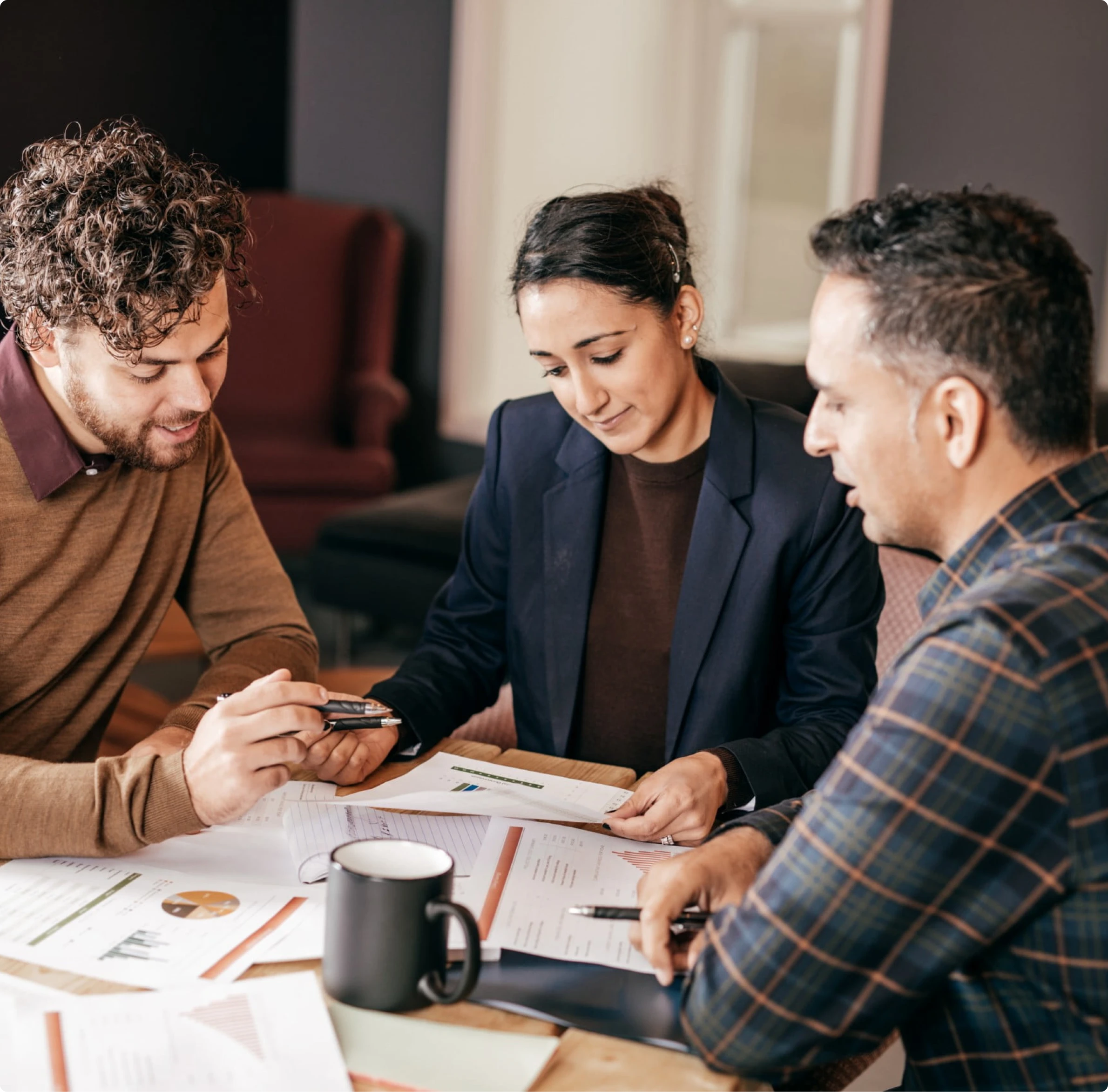 Mortgage professionals reviewing loan documents and discussing home loan financing solutions with guidance from MambaCap Financial mortgage broker services.